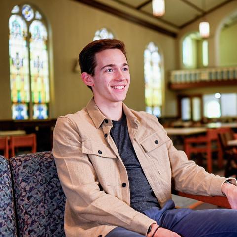 Dan Malatesta sits on a sofa in a Lehigh classroom.